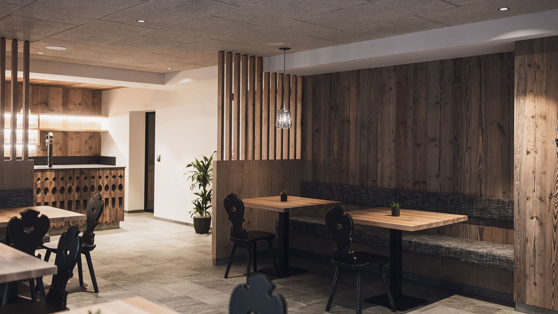 Cozy dining area with wood paneling and modern lighting