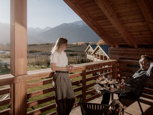 FAQ Two people enjoying coffee on a balcony with mountain view in the morning
