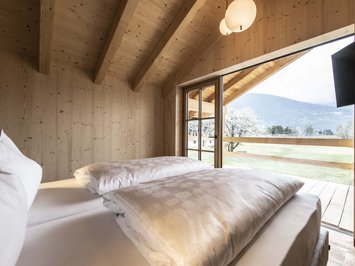 Chalet with a sauna and so much more: Kessler’s Wooden bedroom with open window and mountain view
